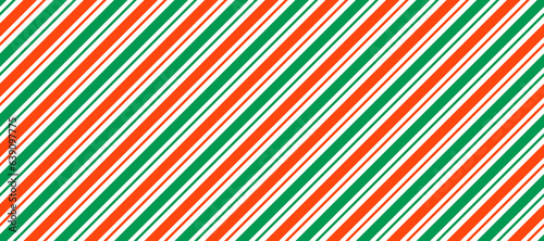Red and green Christmas seamless pattern. Candy cane diagonal stripes background. Repeating decoration wallpaper. Winter holiday lines backdrop. Xmas peppermint present wrapping print design. Vector