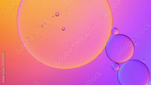 gold and violet color artistic of oil drop floating on the water. Pastel color bubble for background. Fantastic structure of colorful oil bubbles.
