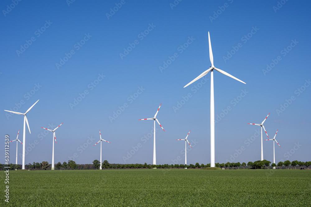 Modern wind turbines in an agricultural landscape seen in Germany Modern wind turbines in an agricultural landscape seen in Germany