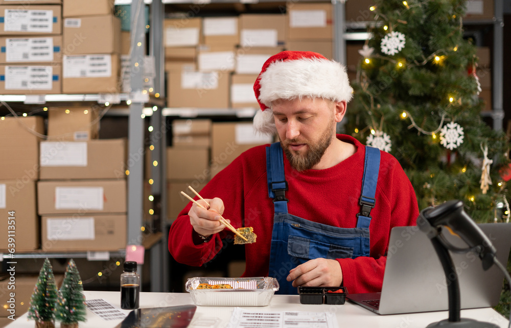 Warehouse worker eating sushi at workplace has lunch break, food at work concept. Warehouse worker eating sushi at workplace has lunch break, food at work concept.