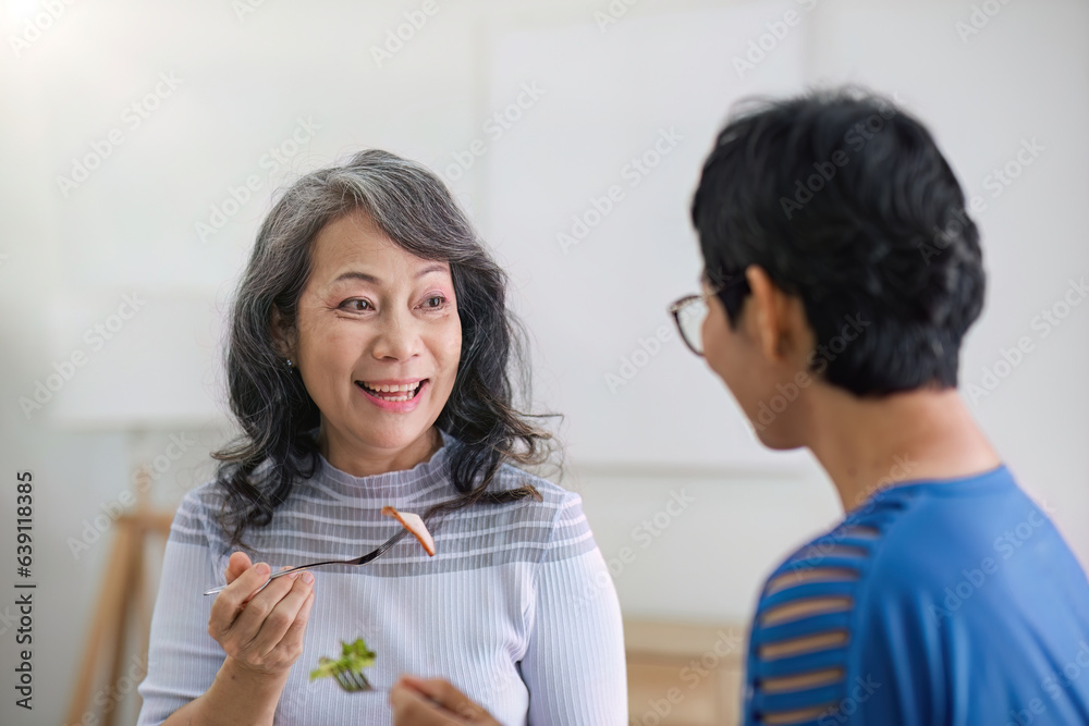 two 60s woman enjoys talking with her friends and having a healthy food together. two 60s woman enjoys talking with her friends and having a healthy food together.