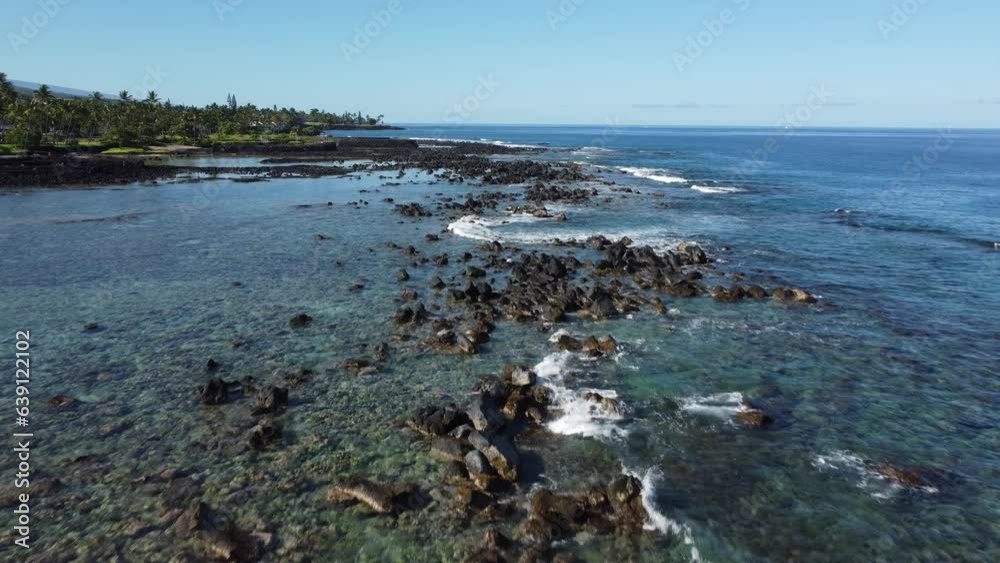 aerial view of the coast in Hawaii with blue sea, sunny sky, beach, and trees aerial view of the coast in Hawaii with blue sea, sunny sky, beach, and trees