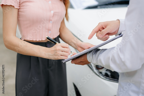 Customers and car insurance agents have entered into agreements and signed documents to claim compensation after a car crash  Insurance concept