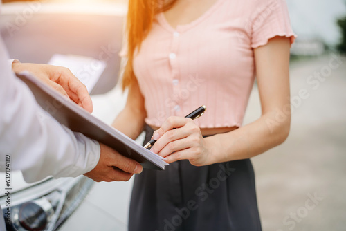Customers and car insurance agents have entered into agreements and signed documents to claim compensation after a car crash, Insurance concept