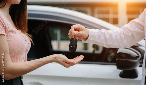 Automotive business  car sale or rental concept Customer with car dealer agent making deal and signing on agreement document contract in auto showroom or on road