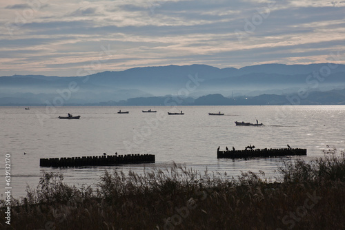 Canvas-taulu Early morning whitebait fishing in the lake