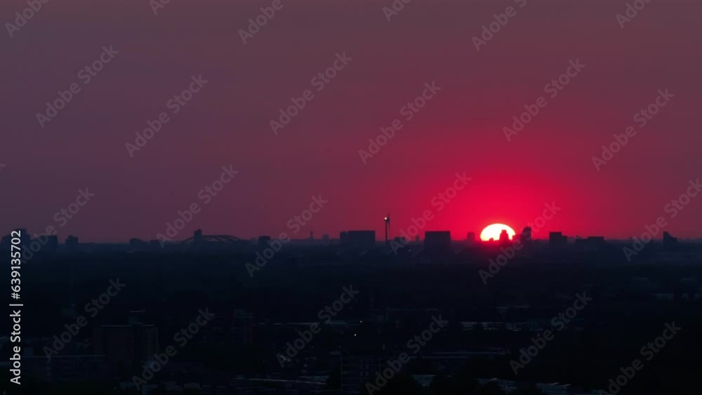 Sun is just rising behind the silhouettes of a city. Red sunrise background Sun is just rising behind the silhouettes of a city. Red sunrise background