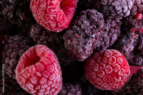 Micro close up of frozen raspberries with copy space