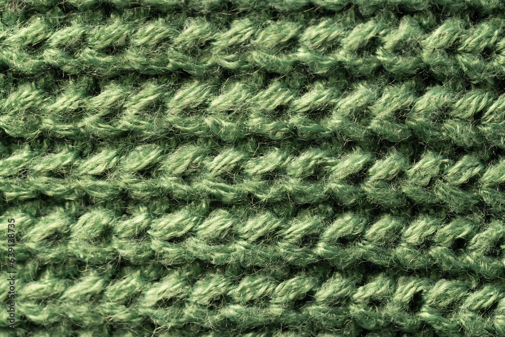 Micro close up of green wooly knitted fabric with copy space Micro close up of green wooly knitted fabric with copy space