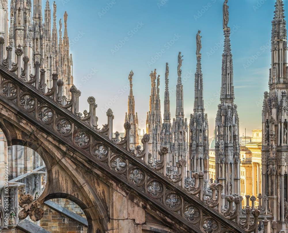 Flying buttress and rows of pinnacle sculptures on the rooftop aisle of Milan Cathedral