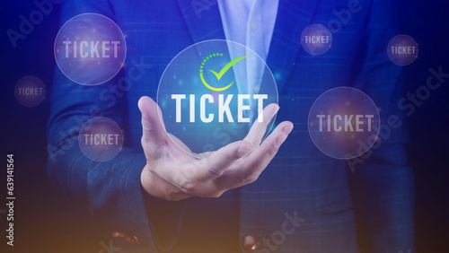 Businessman holding with button Ticket word, Business, Technology, internet and networking concept businessman pressing online booking button on virtual screens.
