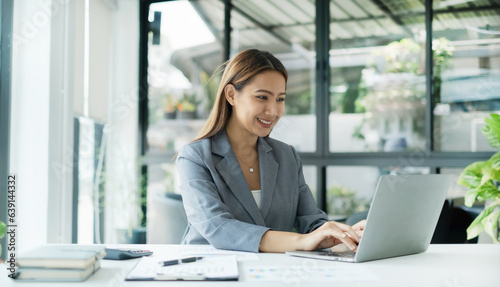 Asian businesswoman calculate financial graphs showing results about their investments, planning successful business growth process