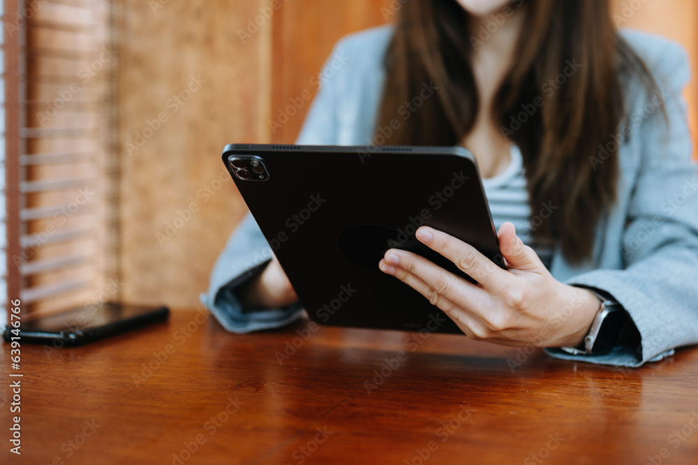Confident businesswoman working on laptop,tablet and smartphone at her workplace at office.. Confident businesswoman working on laptop,tablet and smartphone at her workplace at office..