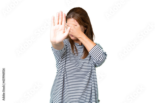 Middle age woman over isolated background making stop gesture and covering face