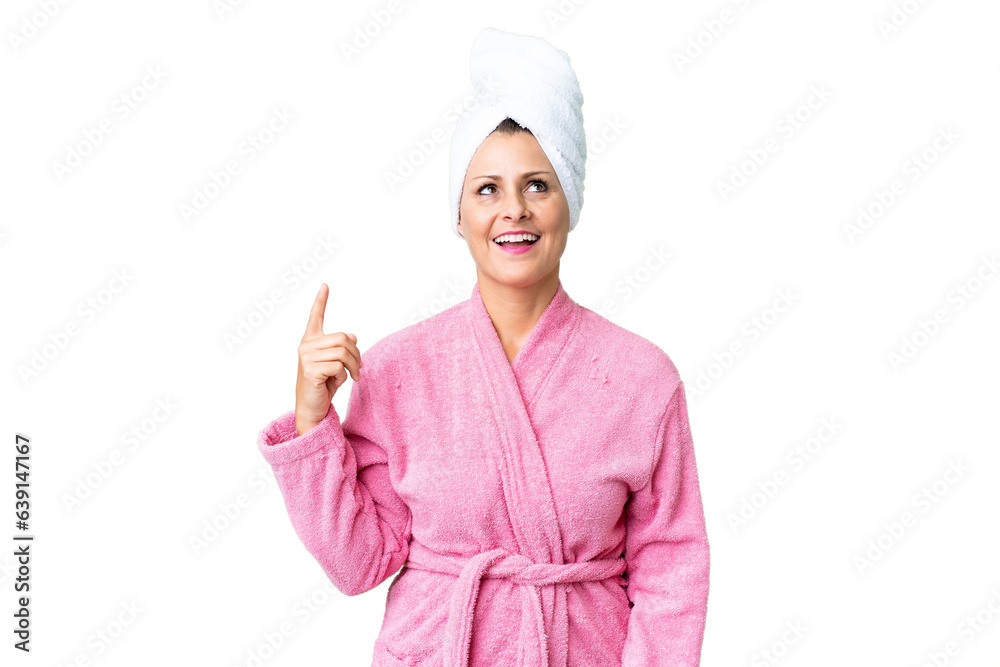 Middle age caucasian woman in a bathrobe over isolated background pointing up and surprised Middle age caucasian woman in a bathrobe over isolated background pointing up and surprised