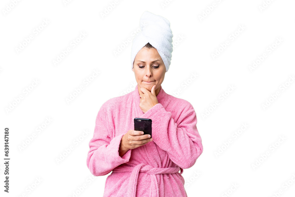 Middle age caucasian woman in a bathrobe over isolated background thinking and sending a message Middle age caucasian woman in a bathrobe over isolated background thinking and sending a message