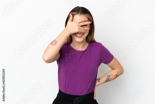 Young caucasian woman isolated on white background covering eyes by hands and smiling