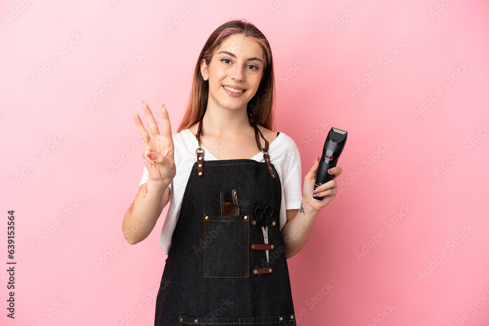 Young hairdresser woman isolated on pink background happy and counting three with fingers Young hairdresser woman isolated on pink background happy and counting three with fingers