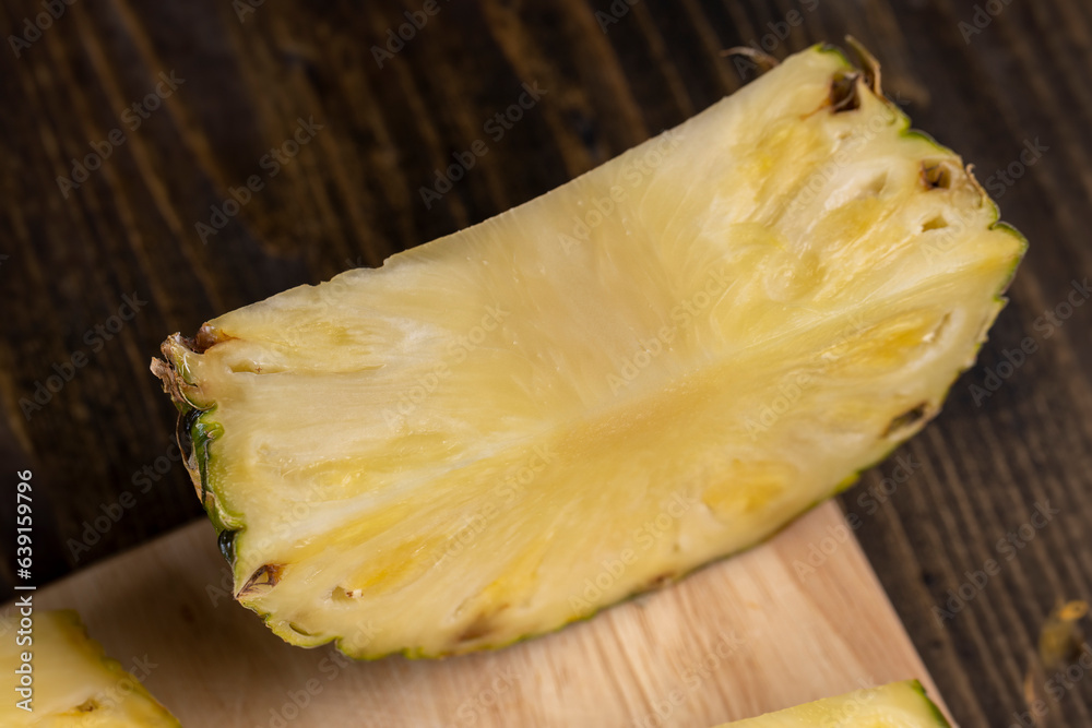 sliced ripe yellow pineapple, a large number of pieces sliced ripe yellow pineapple, a large number of pieces