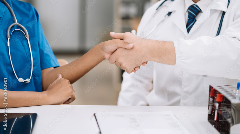 Doctors shaking hands, working together as a team. Doctors shaking hands, working together as a team.