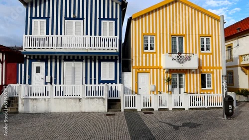 Tilt down shot of two stripped and colorful houses in Costa Nova, Portugal