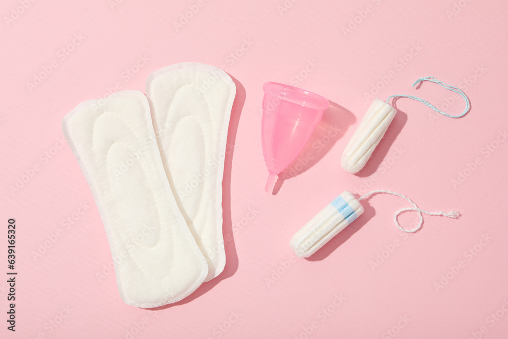Menstrual feminine hygiene products on a pink background Menstrual feminine hygiene products on a pink background