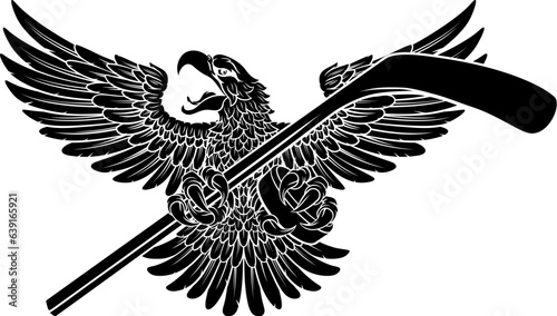 A bald eagle or hawk flying with an ice hockey puck and stick in its claws sports mascot