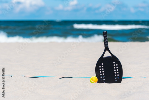 Racket and ball on the sandy beach. Summer sport concept. Horizontal sport theme poster, greeting cards, headers, website and app