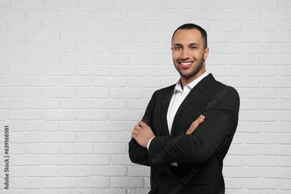 Young businessman in formal outfit near white brick wall. Space for text Young businessman in formal outfit near white brick wall. Space for text