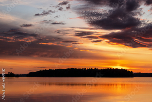 Sunset over finnish landscape with water and forest in summer at Lake Saimaa, Karelia, Finland © sg-naturephoto.com 