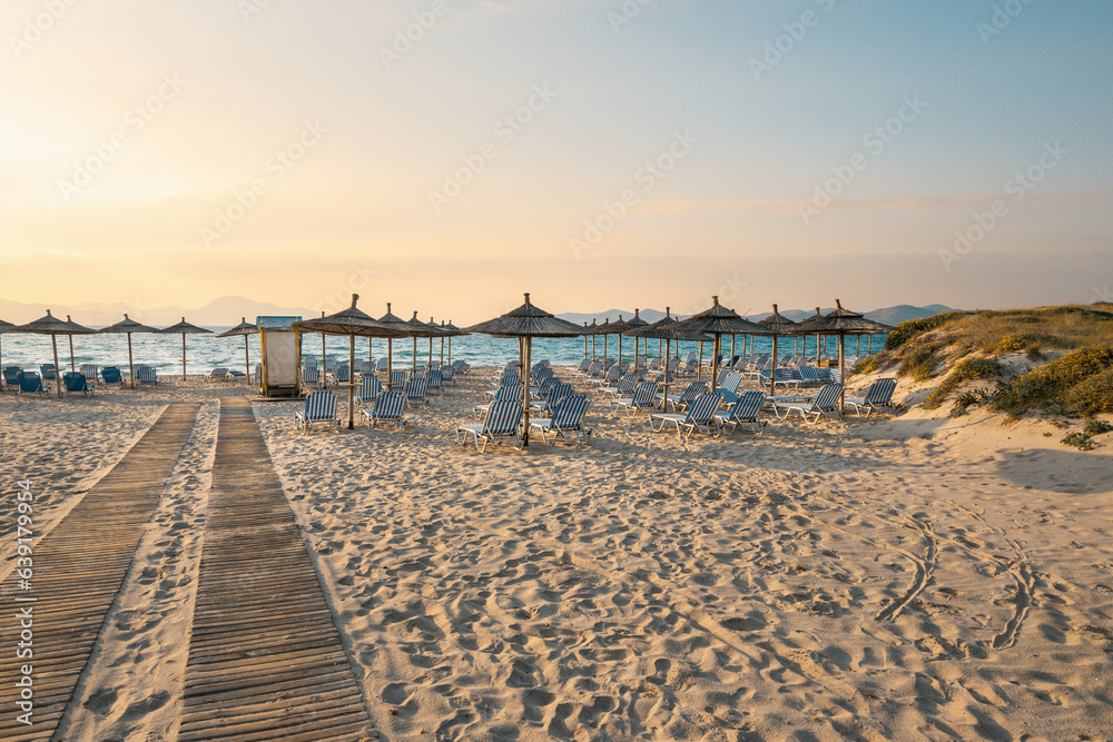 Sunbeds with umbrella on sandy beach of Marmari. The Greek island of Kos