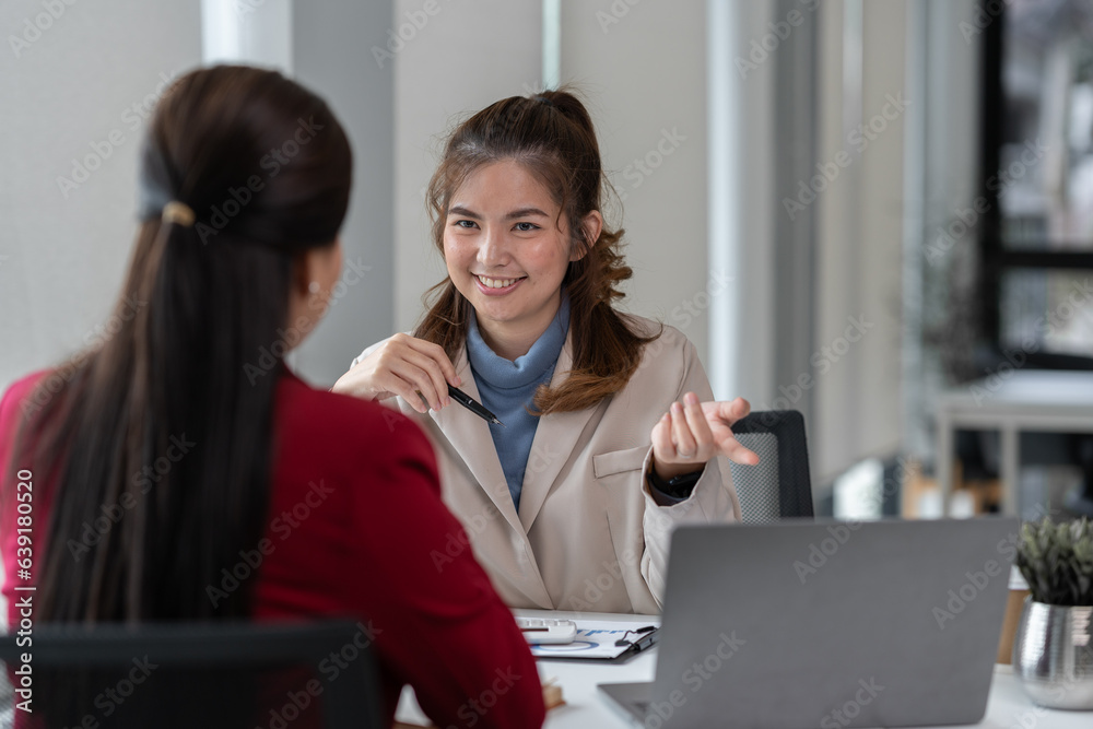 Manager or supervisor with two asian businesswoman having a discussion communication Negotiate project documents Analyze the marketing plan. business investment in finance, tax, office interior Manager or supervisor with two asian businesswoman having a discussion communication Negotiate project documents Analyze the marketing plan. business investment in finance, tax, office interior