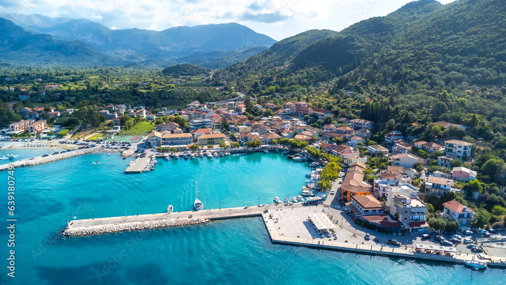 Aerial view of the port of the coastal village of Vasiliki in the south of the island of Lefkada, Greece. Beautiful crystal clear turquoise and blue waters