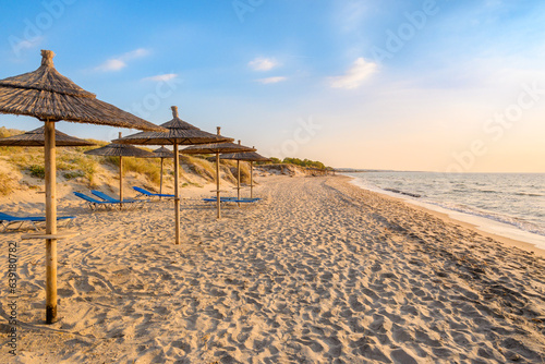 Straw umbrellas on sandy beach of Marmari. The Greek island of Kos