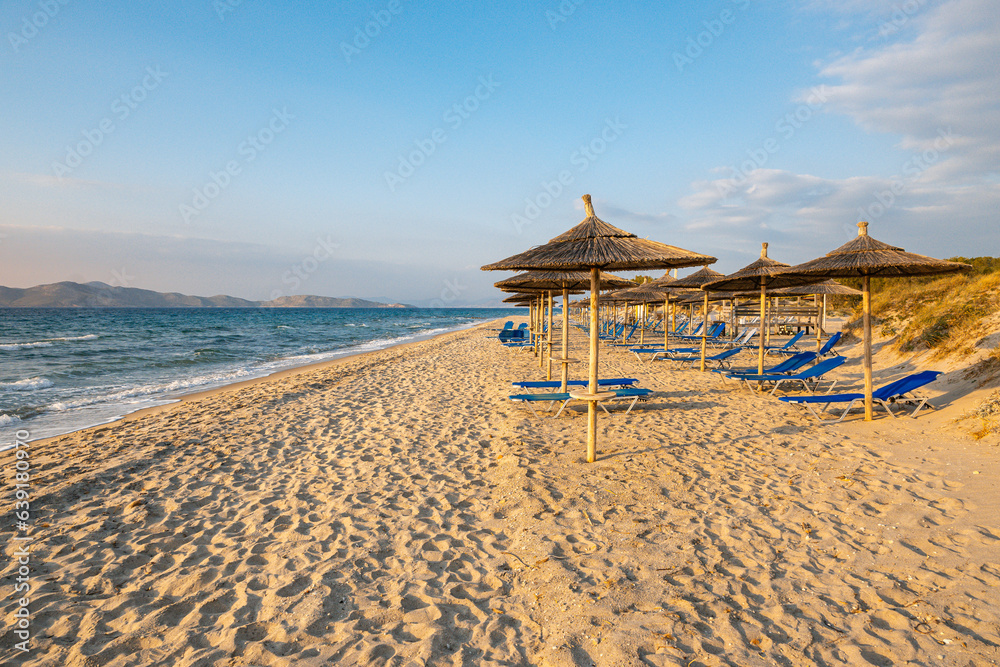 Straw umbrellas on sandy beach of Marmari. The Greek island of Kos