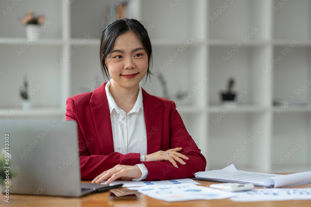 Attractive Asian businesswoman excited with laptop computer smartphone Finance, accounting, marketing, tax paperwork on office desk Attractive Asian businesswoman excited with laptop computer smartphone Finance, accounting, marketing, tax paperwork on office desk