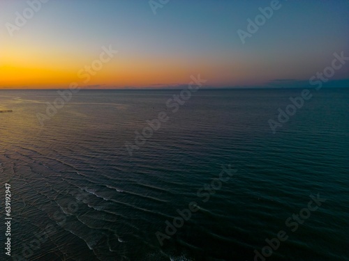Italy  Rimini 15.08.2023  Beautiful sunset in Rimini. Drone photography of the city and the beach. Spectacular sunset on Adriatic coast. Vacation concept background. Rimini public beach. Panoramic sum