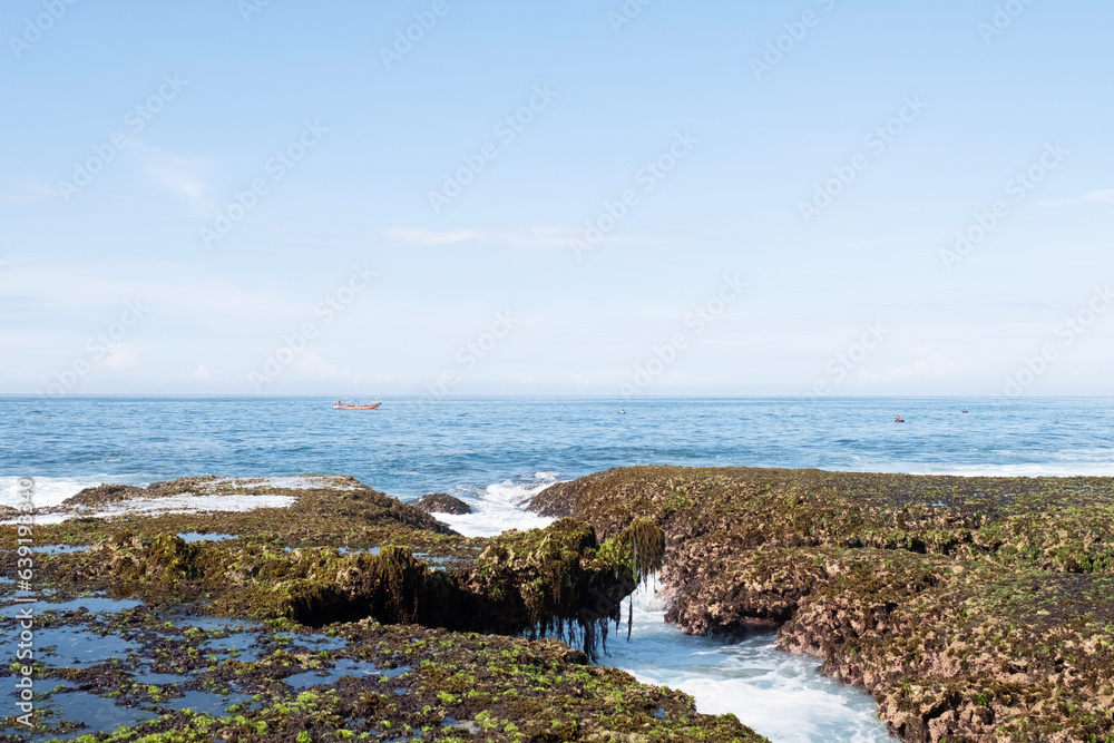 Sawarna beach,west Java,Indonesia, beautiful beach with coral reefs dotted with greenery Sawarna beach,west Java,Indonesia, beautiful beach with coral reefs dotted with greenery