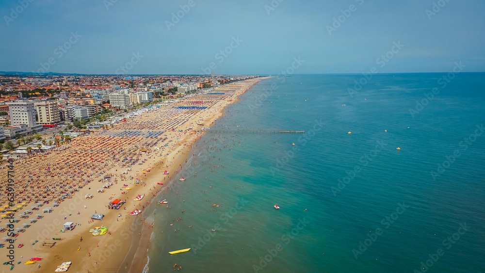 Long Sea beach on the Adriatic Sea with vacationing people, view from a drone. Summer vacation, tourism and travel concept.