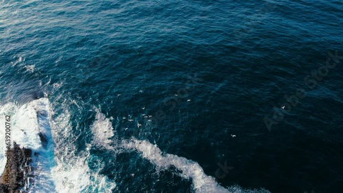 Wallpaper Mural Top down view on ocean waves crashing and foaming around majestic rocks and cliffs. Inspiring and incredible nature concept. Drone shot of powerful sea water on epic coastline Torontodigital.ca