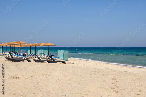 Sunbeds with umbrella on sandy beach of Marmari. The Greek island of Kos