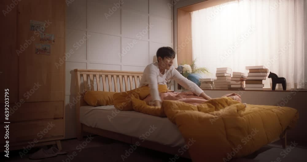 Handsome Korean Young Man Wakes Up in his Bed, Sun Shines on Him, He Greets a New Sunny Day at Home and Stretches. Joyful Waking Up of an Asian Male Who is Ready for Productive Day Handsome Korean Young Man Wakes Up in his Bed, Sun Shines on Him, He Greets a New Sunny Day at Home and Stretches. Joyful Waking Up of an Asian Male Who is Ready for Productive Day