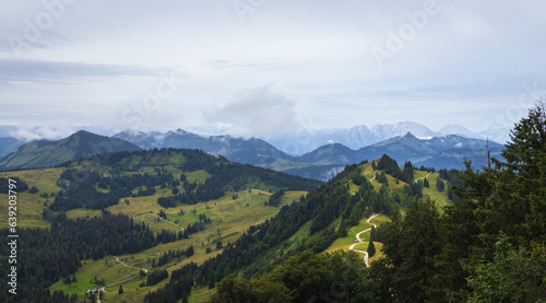 Meadow hill in Alps mountain valley with fog. Austria landscape background © Space Creator