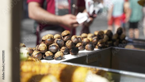 People buy famous turkey roasted chestnut In the cart on Istiklal Avenue. Popular street food in Istanbul