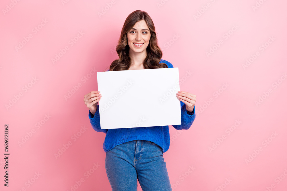 Photo portrait of attractive young woman hold white blank paper sheet wear trendy blue clothes isolated on pink color background Photo portrait of attractive young woman hold white blank paper sheet wear trendy blue clothes isolated on pink color background