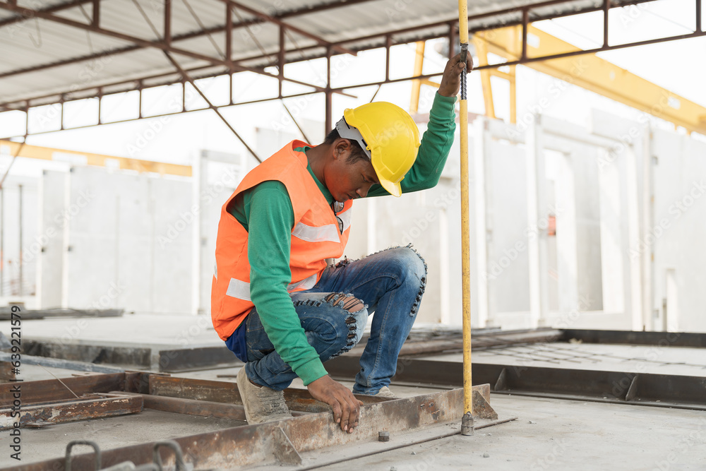 Fototapeta premium Asian male builder worker working at construction site. Male mason working at construction site