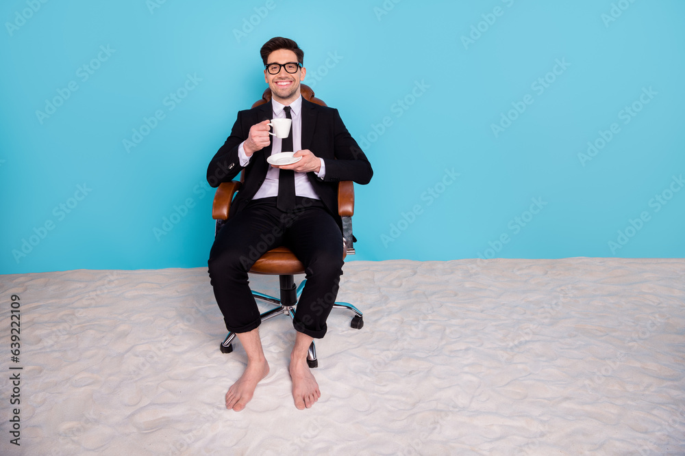 Full length photo of cheerful positive man wear black suit drinking coffee distance working isolated blue color background Full length photo of cheerful positive man wear black suit drinking coffee distance working isolated blue color background