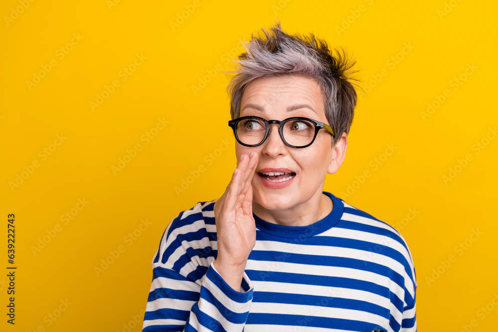 Photo of girlish young woman attractive grey dyed hair person hand cheek speak secrets empty space isolated on yellow color background Photo of girlish young woman attractive grey dyed hair person hand cheek speak secrets empty space isolated on yellow color background
