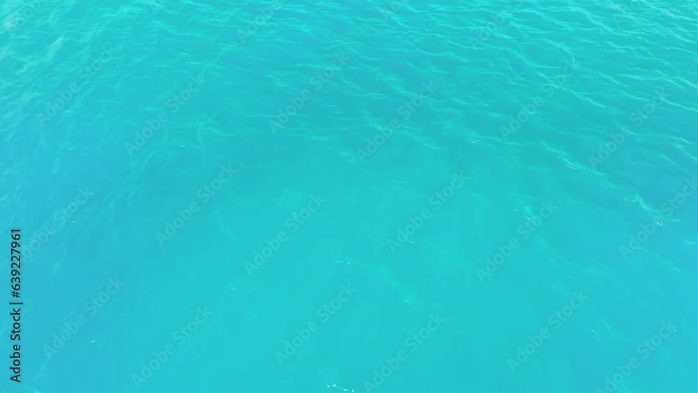 Aerial view of the sea surface, bird's eye view photo of turquoise waves and water texture. Blue sea background. Beautiful nature. Amazing sea view. Aerial view of the sea surface, bird's eye view photo of turquoise waves and water texture. Blue sea background. Beautiful nature. Amazing sea view.
