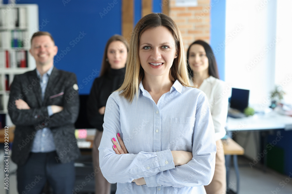 Portrait of confident business woman behind business team. Successful marketing professionals concept Portrait of confident business woman behind business team. Successful marketing professionals concept